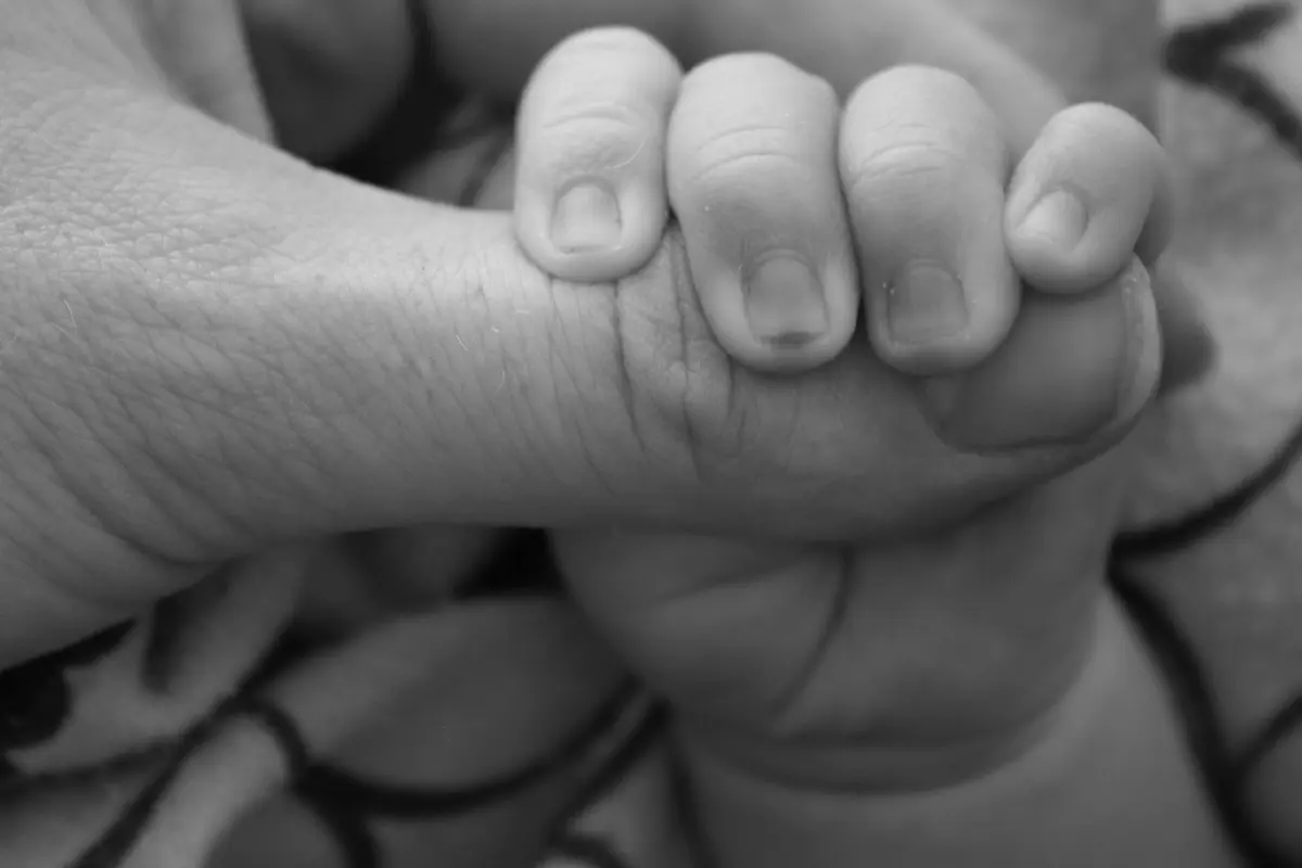 Baby Holding the Hand of a Parent
